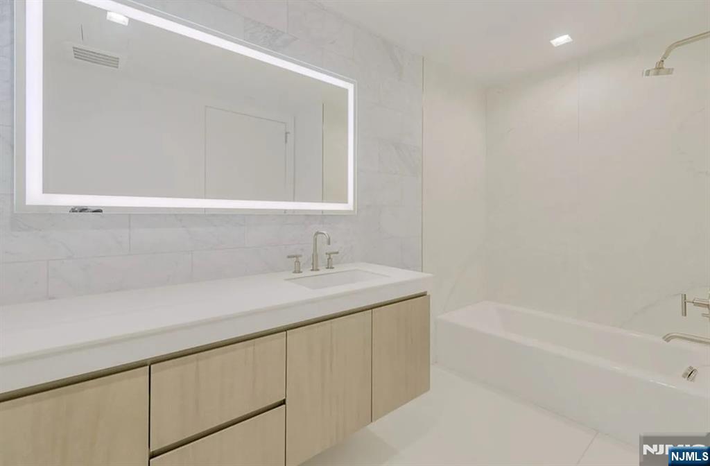 320 Adolphus Avenue, Unit 117 Cliffside Park, NJ 07010 - Photo 8 of 27 a bathroom with a sink and a bathtub