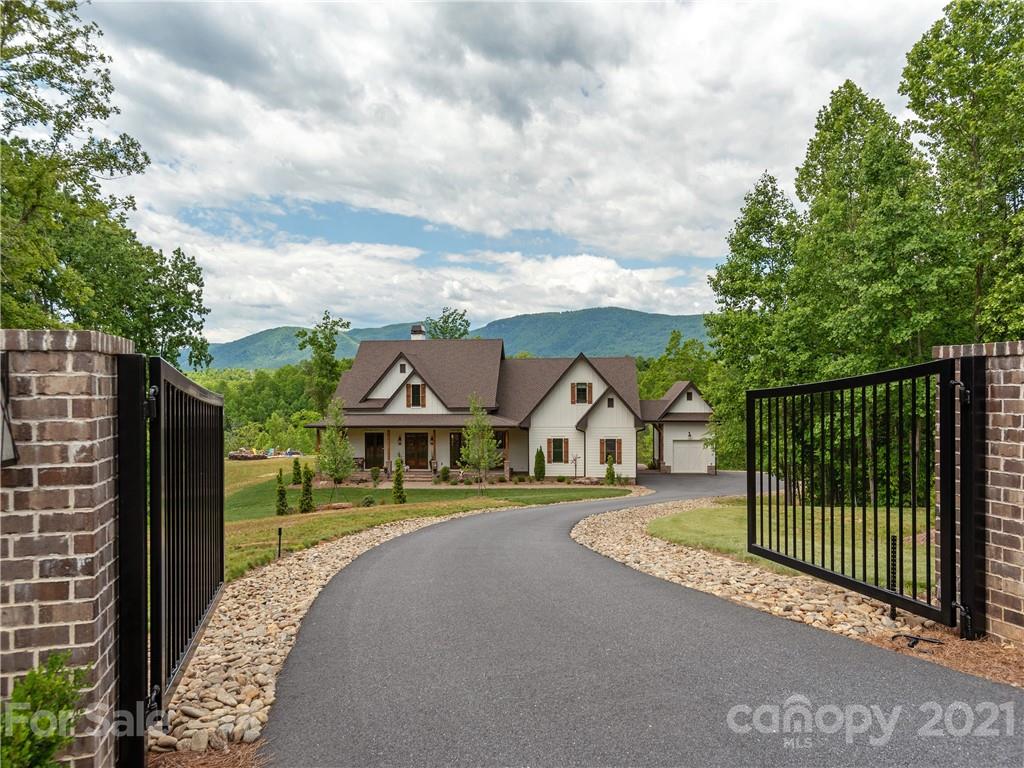 570 Parkway North Rd Mill Spring Mill Spring, NC 28756 - Photo 2 of 48 a view of a house with a big yard and a large tree