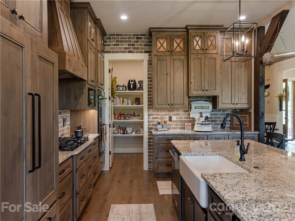 570 Parkway North Rd Mill Spring Mill Spring, NC 28756 - Photo 18 of 48 a kitchen with stainless steel appliances granite countertop a refrigerator a stove and a sink