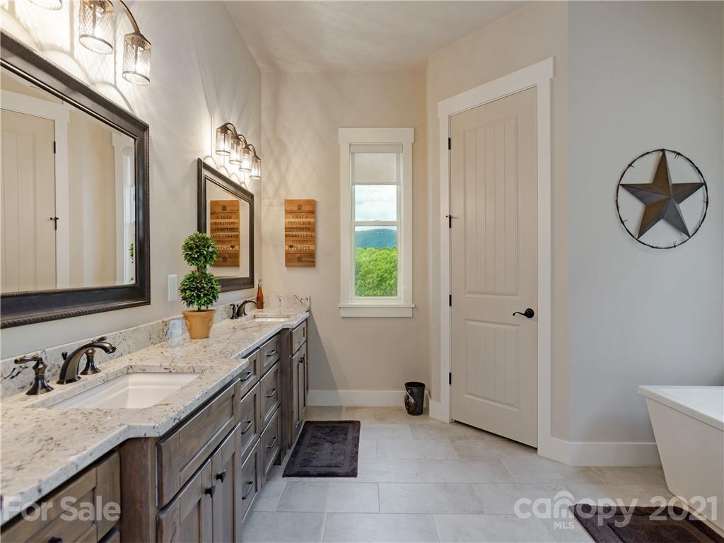 570 Parkway North Rd Mill Spring Mill Spring, NC 28756 - Photo 24 of 48 a bathroom with a granite countertop sink and a mirror