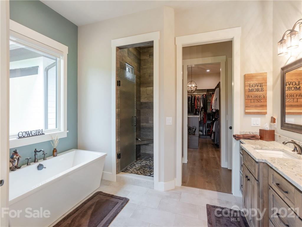 570 Parkway North Rd Mill Spring Mill Spring, NC 28756 - Photo 25 of 48 a bathroom with a tub sink and mirror