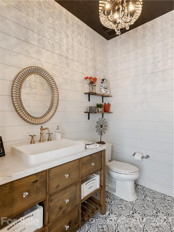 570 Parkway North Rd Mill Spring Mill Spring, NC 28756 - Photo 28 of 48 a bathroom with a toilet a sink and mirror