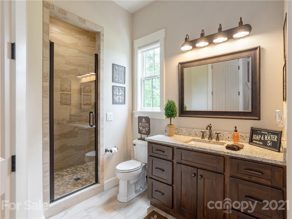 570 Parkway North Rd Mill Spring Mill Spring, NC 28756 - Photo 30 of 48 a bathroom with a toilet sink and shower