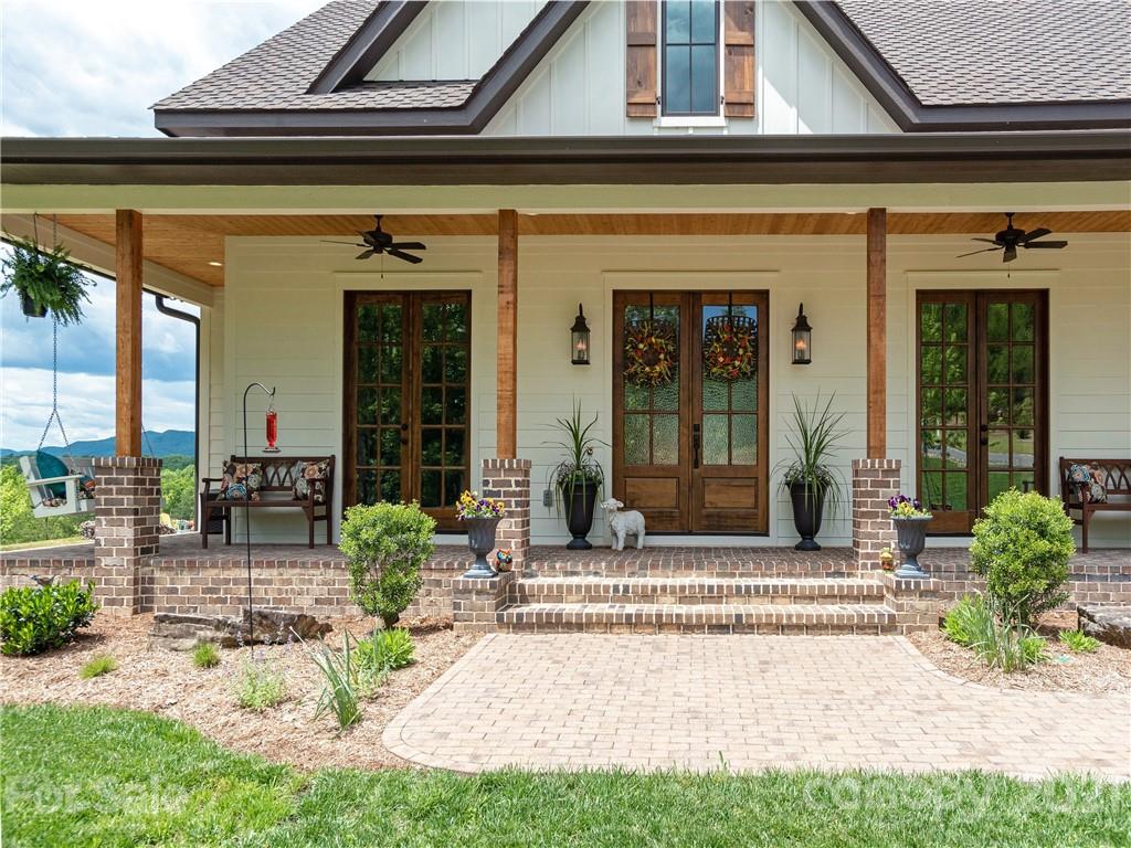 570 Parkway North Rd Mill Spring Mill Spring, NC 28756 - Photo 5 of 48 a front view of a house with a outdoor seating