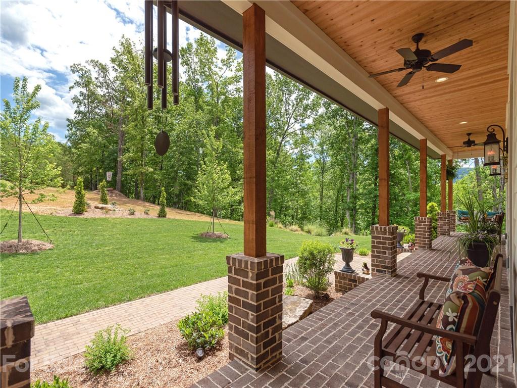 570 Parkway North Rd Mill Spring Mill Spring, NC 28756 - Photo 6 of 48 a view of a patio with a dining table chairs and a yard