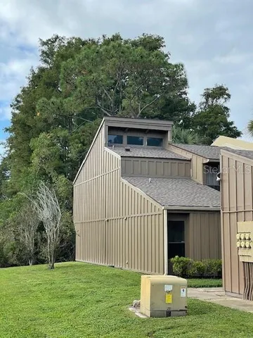 a house view with garden space and trees