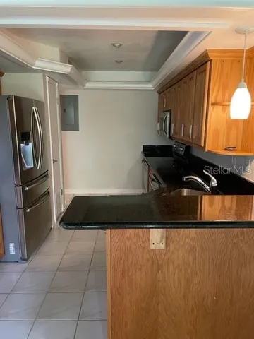 a kitchen with a sink and a refrigerator
