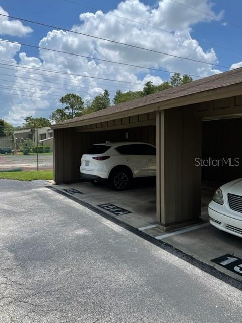 5466 Pine Creek Drive, Unit 2002 Orlando, FL 32811 - Photo 16 of 19 a car parked in front of a house