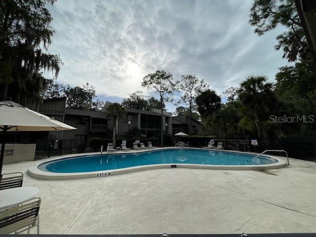 5466 Pine Creek Drive, Unit 2002 Orlando, FL 32811 - Photo 19 of 19 a view of swimming pool with a yard