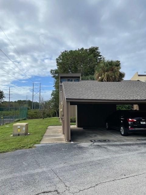 5466 Pine Creek Drive, Unit 2002 Orlando, FL 32811 - Photo 2 of 19 a car parked in front of a house with a small yard