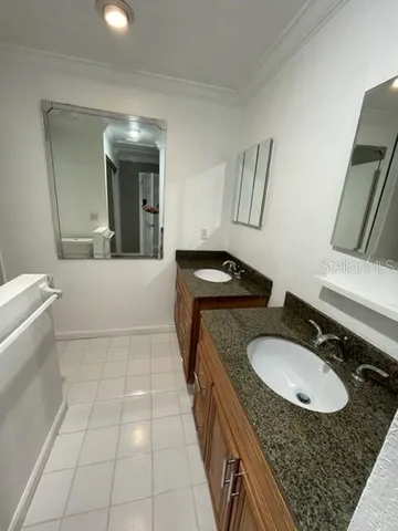 a bathroom with a granite countertop sink a toilet and mirror
