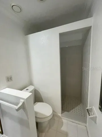 a white toilet sitting next to a bathroom sink