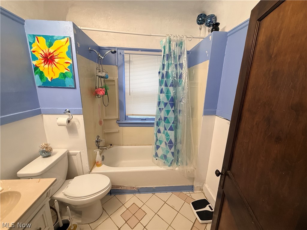 980 Brunswick Road Cleveland Heights, OH 44112 - Photo 4 of 11 Bathroom featuring vanity, shower / bath combo with shower curtain, and light tile patterned flooring
