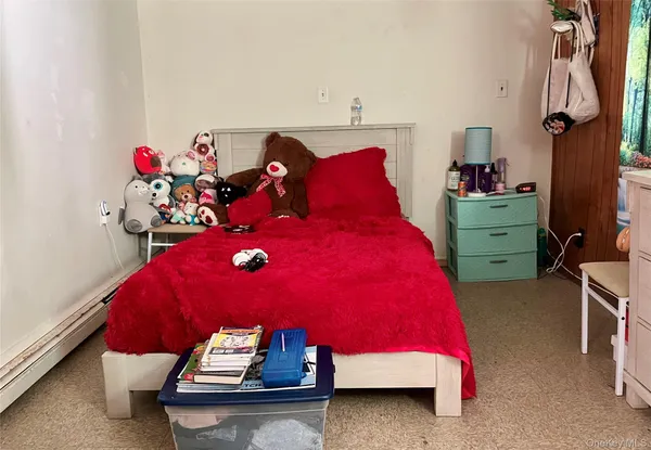 a room with a bed and a dresser