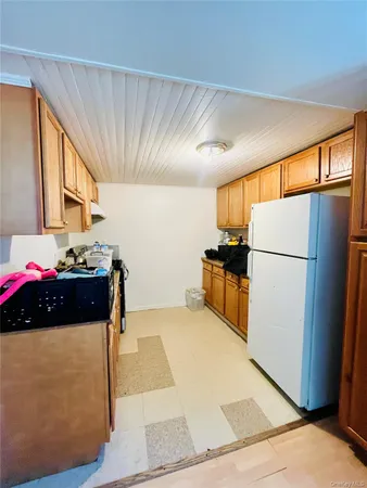 a bedroom with a bed and a view of kitchen