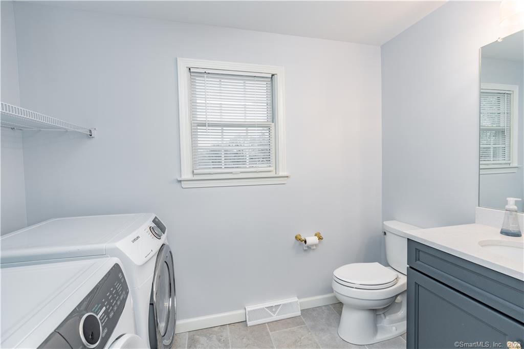 1241 Halladay Avenue West Suffield, CT 06078 - Photo 17 of 29 a white toilet sitting next to a bathroom sink