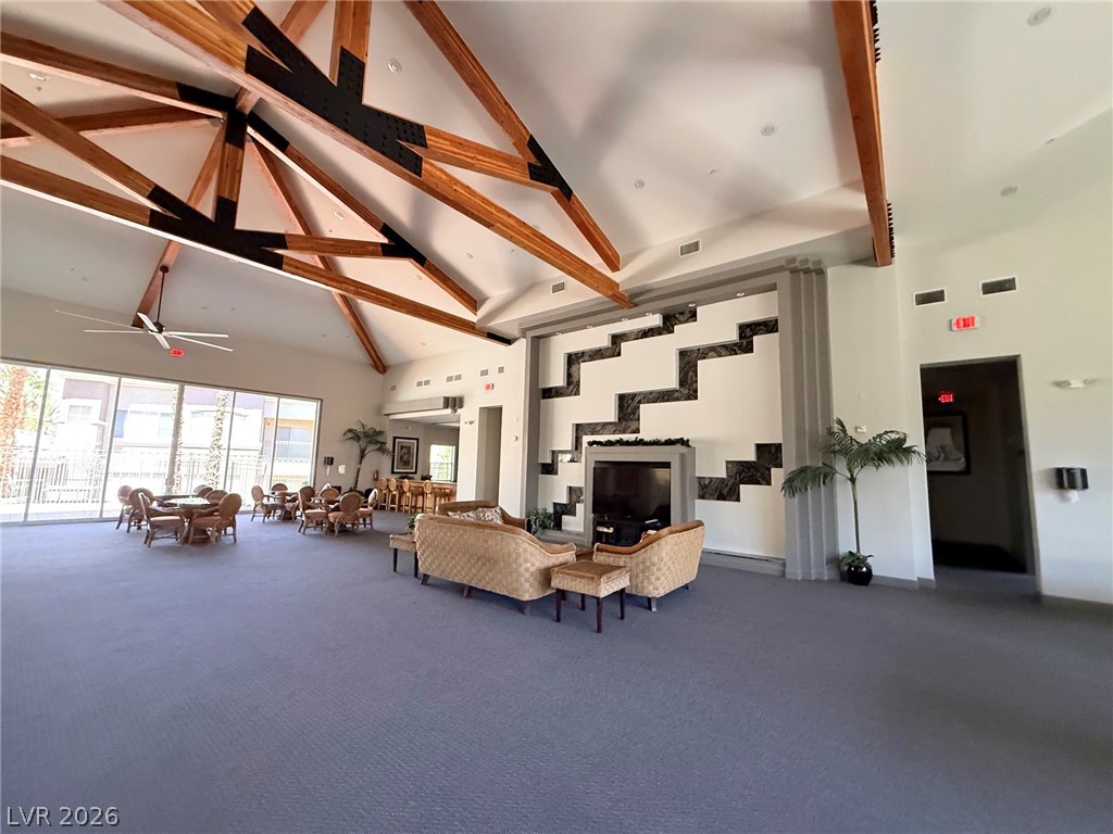 9050 West Warm Springs Road, Unit 2002 Las Vegas, NV 89148 - Photo 44 of 46 This spacious common area features a striking vaulted ceiling and a cozy fireplace, perfect for gatherings.