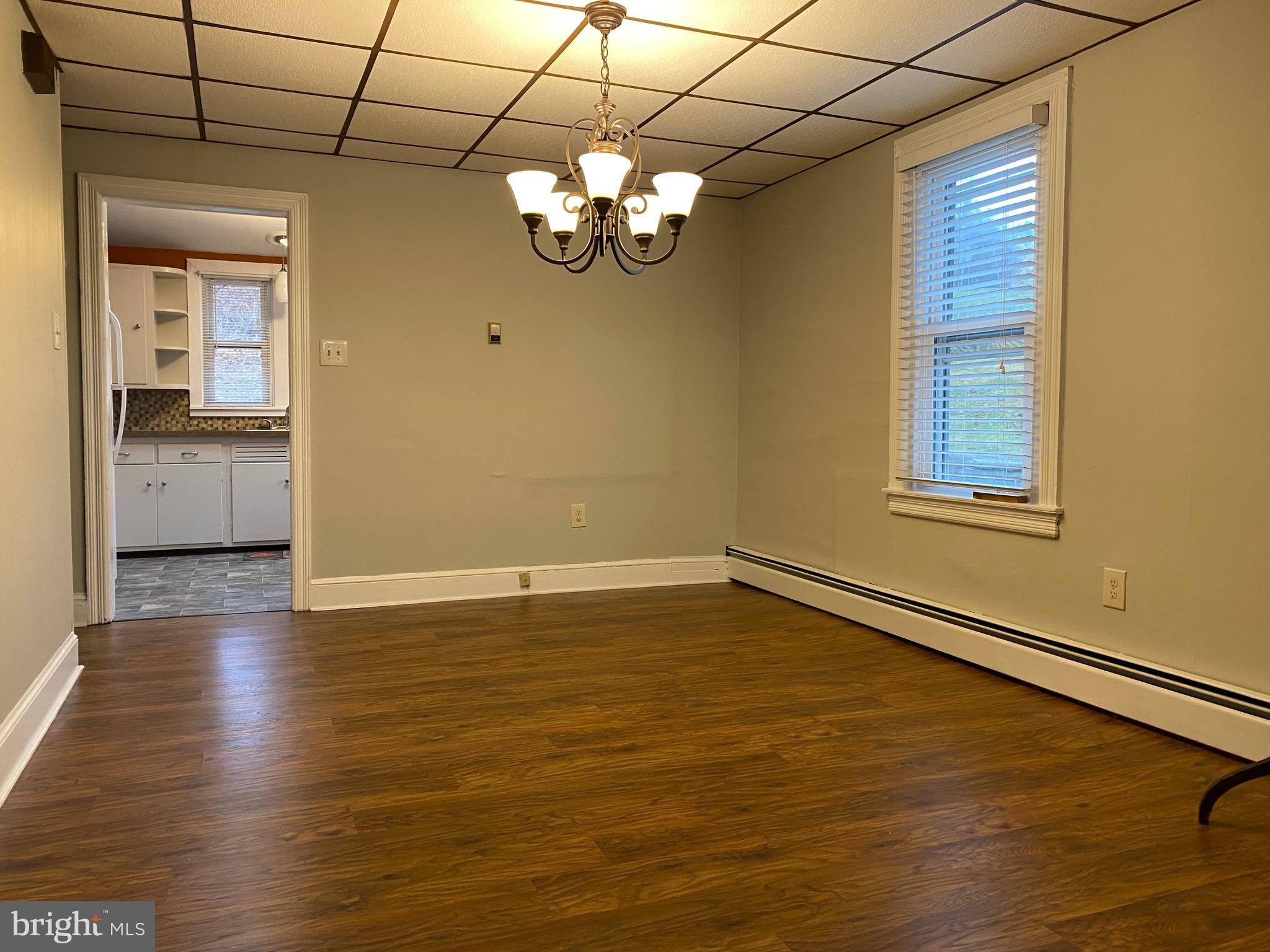 629 Convent Road Aston, PA 19014 - Photo 5 of 19 a view of an empty room with a window and wooden floor