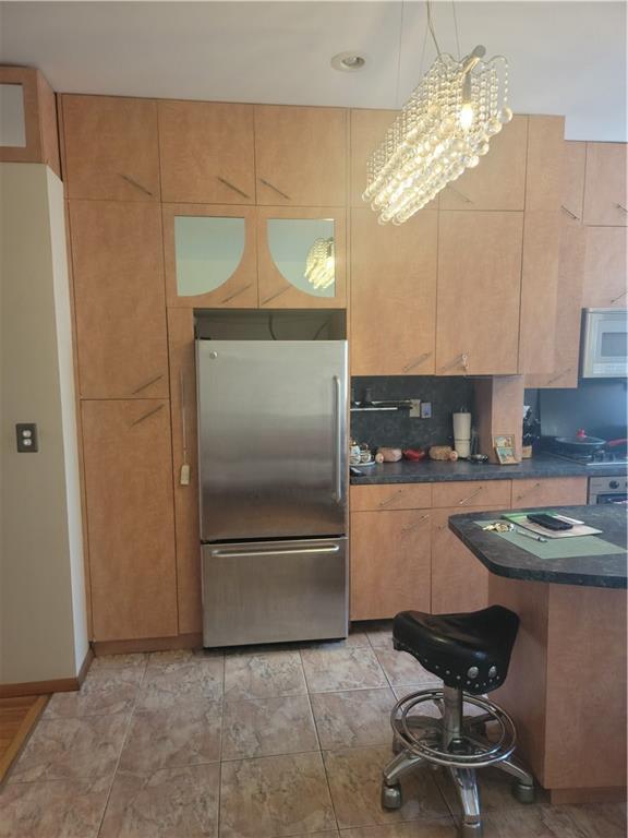 9 Corbin Place Brooklyn, NY 11235 - Photo 16 of 19 a kitchen with cabinets and chairs