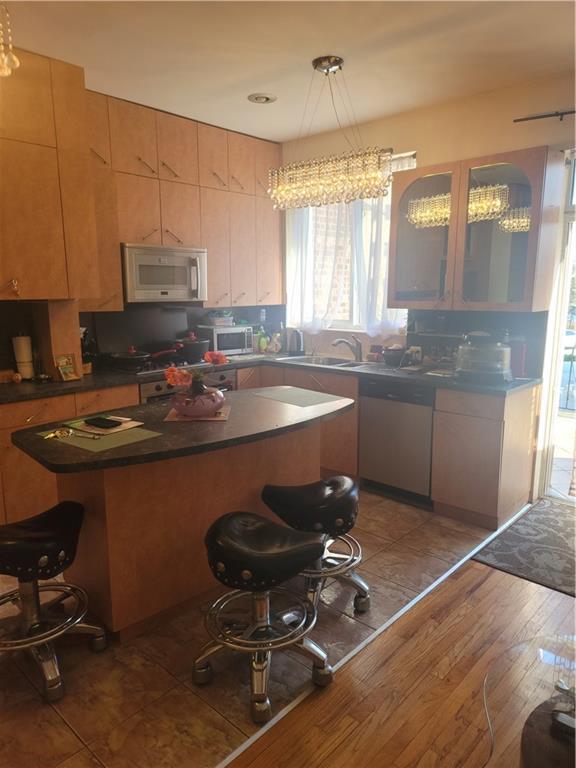 9 Corbin Place Brooklyn, NY 11235 - Photo 17 of 19 a kitchen with a sink chairs and cabinets