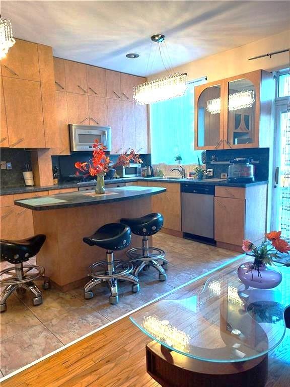 9 Corbin Place Brooklyn, NY 11235 - Photo 2 of 19 a room with stainless steel appliances wooden floor and dining table
