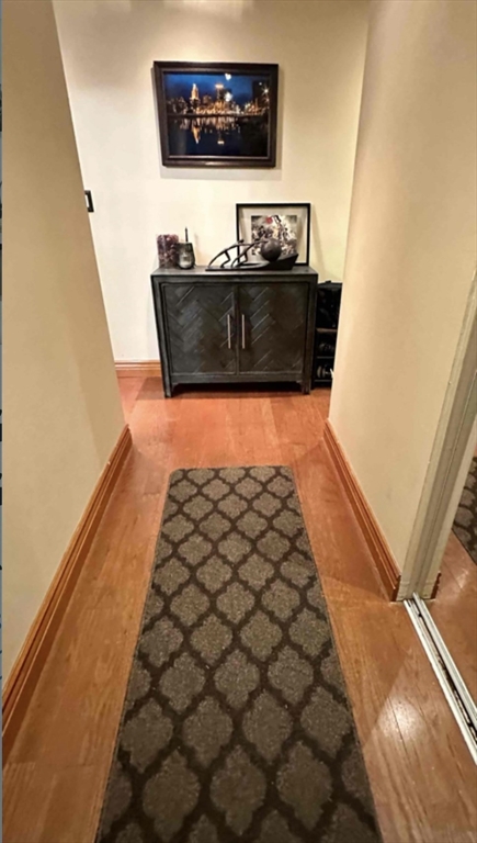 881 Broadway, Unit 9 Chelsea, MA 02150 - Photo 2 of 9 a living room with a couch and a flat screen tv