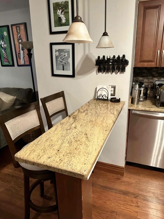 881 Broadway, Unit 9 Chelsea, MA 02150 - Photo 3 of 9 a kitchen with a table and cabinets