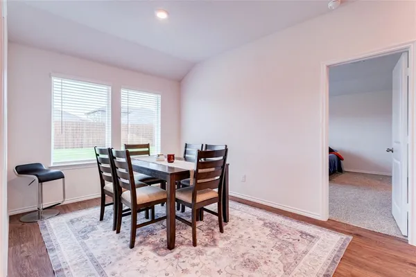 a view of a dining room with furniture and wooden floor