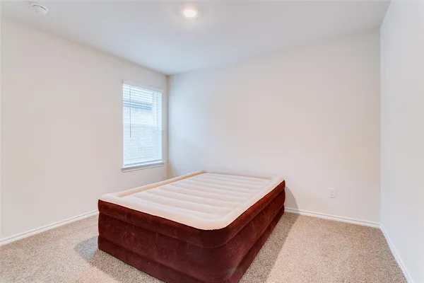 a room with a bed and a window