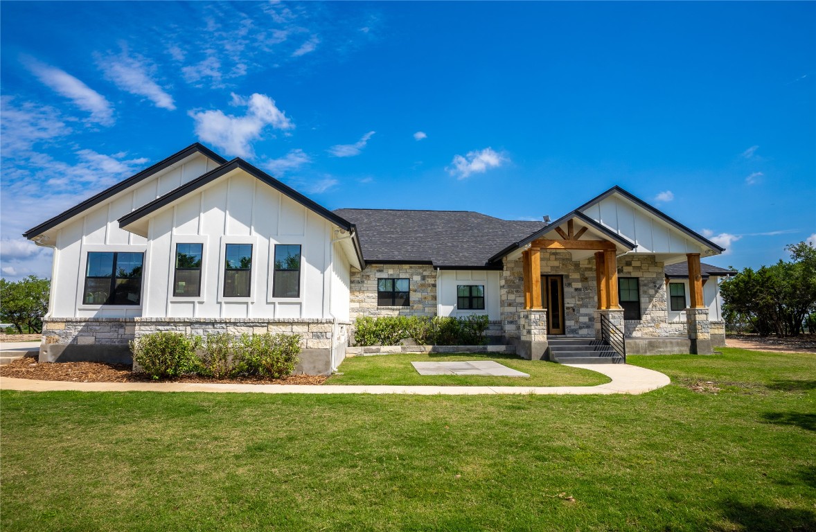 a front view of a house with a yard and porch
