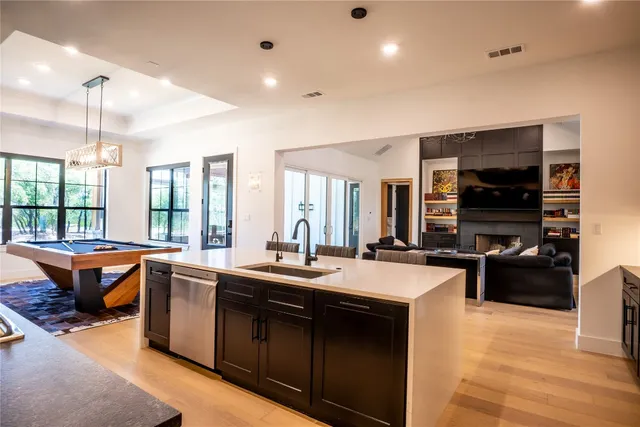 a kitchen with stainless steel appliances kitchen island granite countertop a stove and a microwave