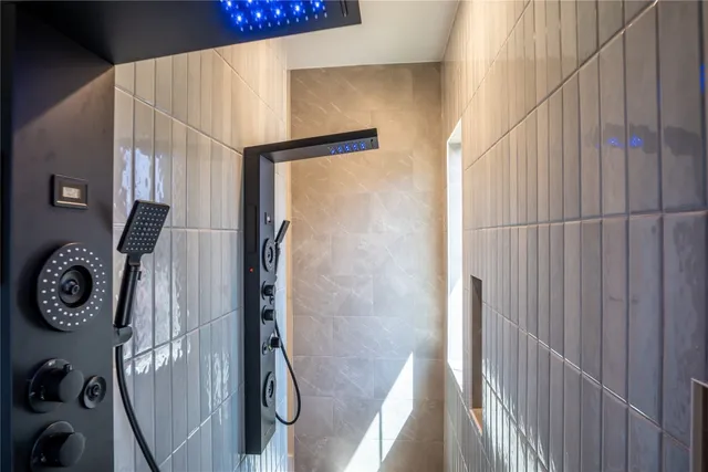 a bedroom with a bed a flat screen tv and a couch