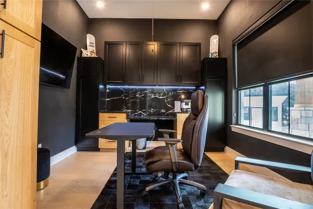 a living room with furniture and a large window with wooden floor