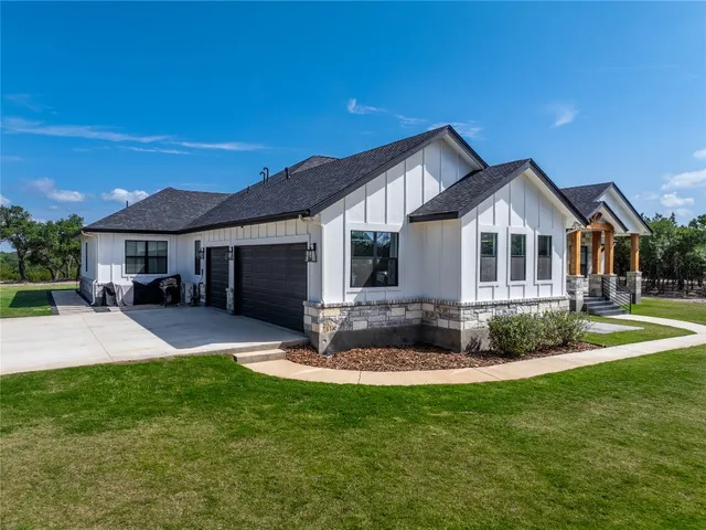 a front view of a house with a yard and porch