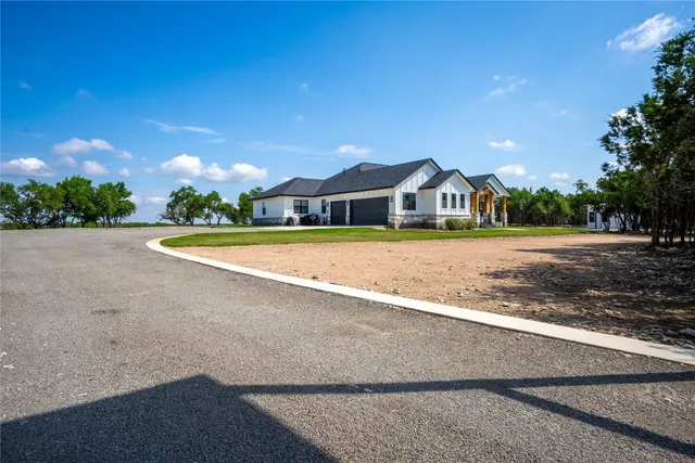 a view of a house with swimming pool and a yard