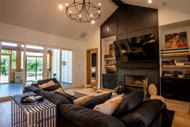 a large kitchen with cabinets table and chairs