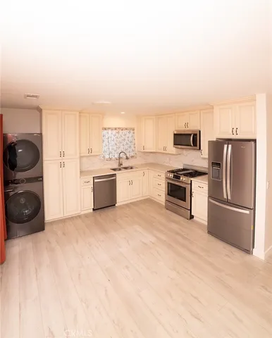 a kitchen with a refrigerator and a stove top oven