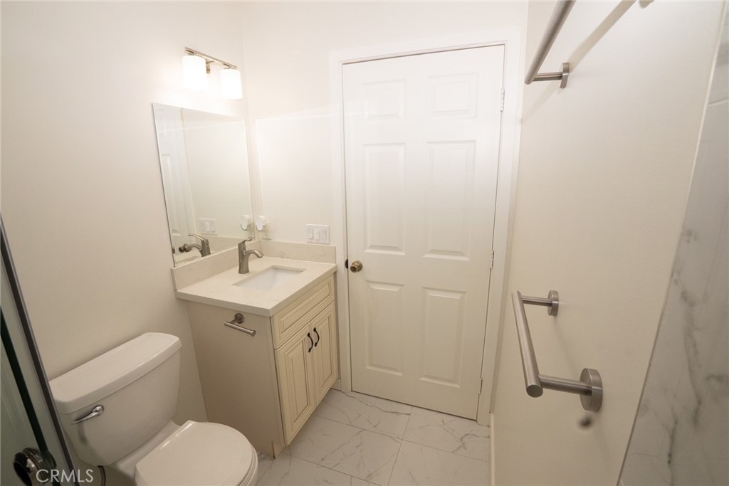 10219 Lev Avenue Arleta, CA 91331 - Photo 5 of 12 a bathroom with a sink a toilet and shower