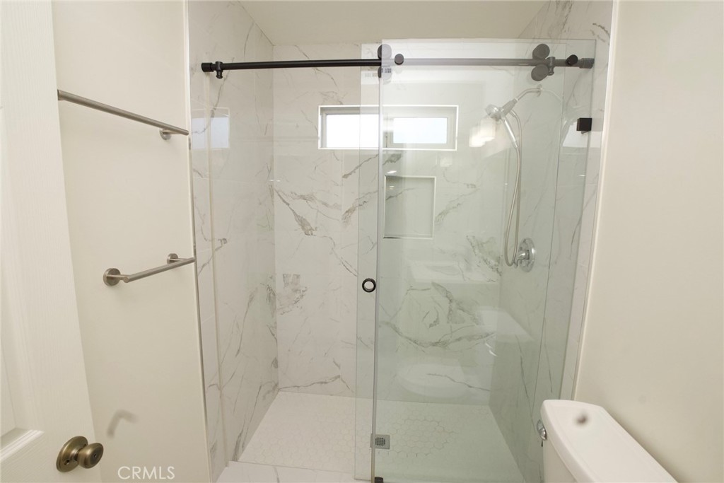 10219 Lev Avenue Arleta, CA 91331 - Photo 7 of 12 a bathroom with a shower and a toilet