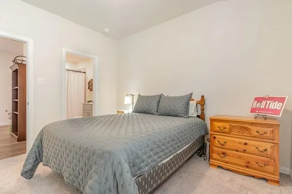 a large bed sitting in a bedroom and dresser