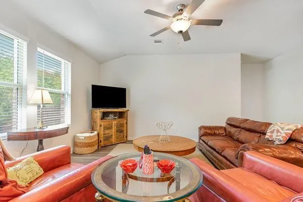 a living room with furniture and a flat screen tv