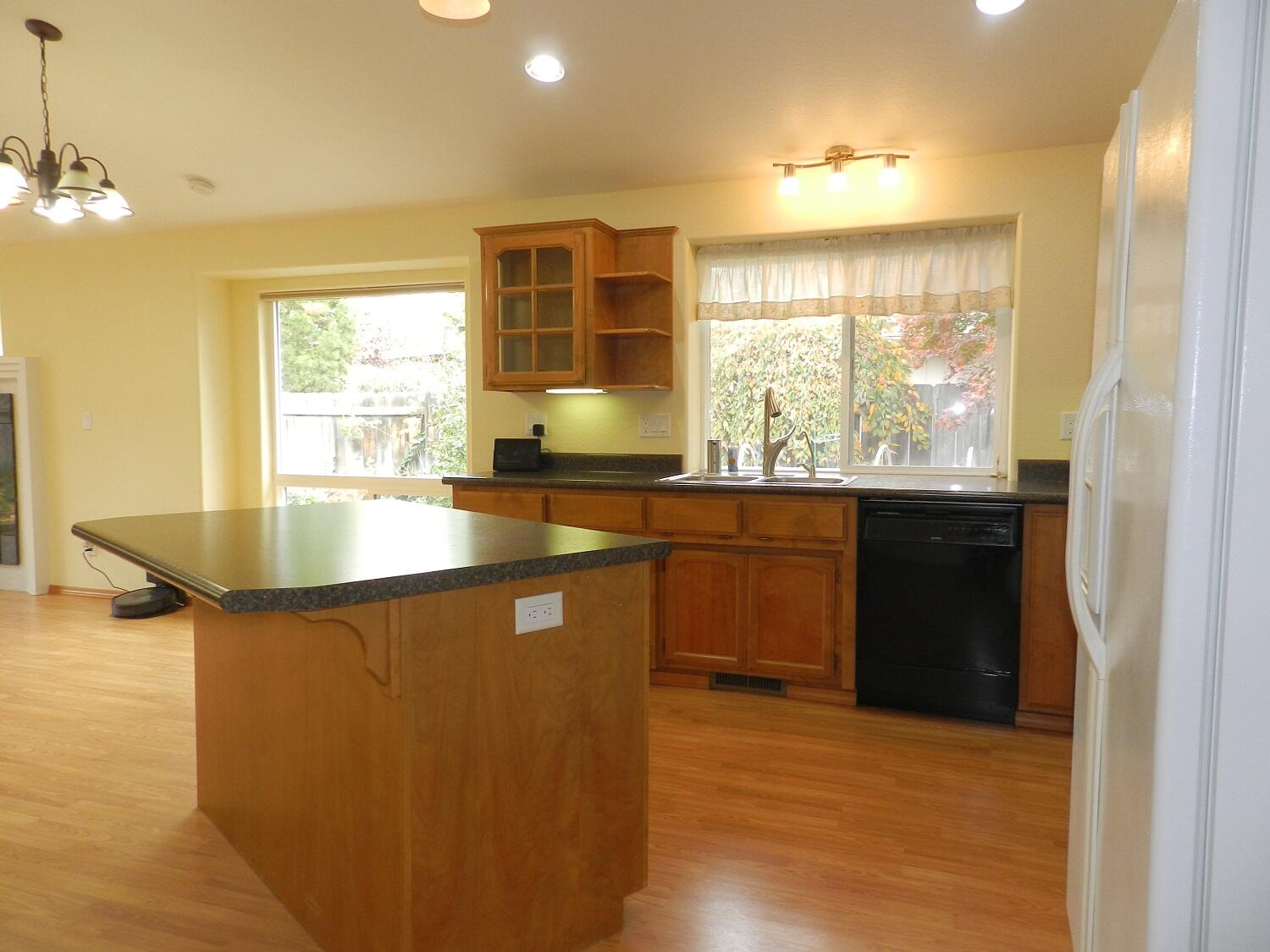 648 Benjamin Way Phoenix, OR 97535 - Photo 5 of 29 a kitchen with a sink stove and cabinets