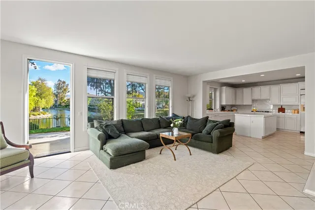 a spacious bedroom with a bed and a painting on the wall