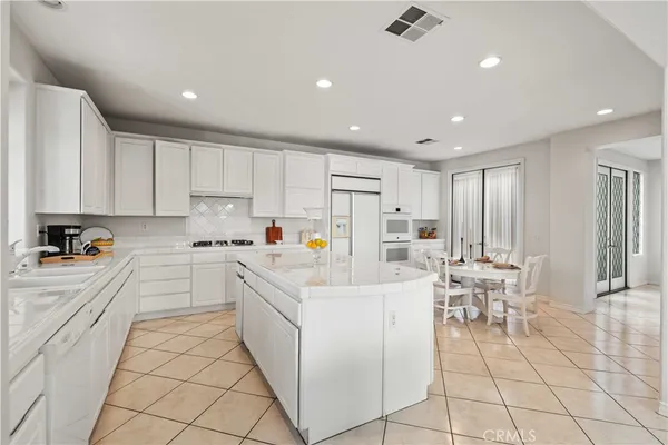 a hallway with cabinets and wooden floor