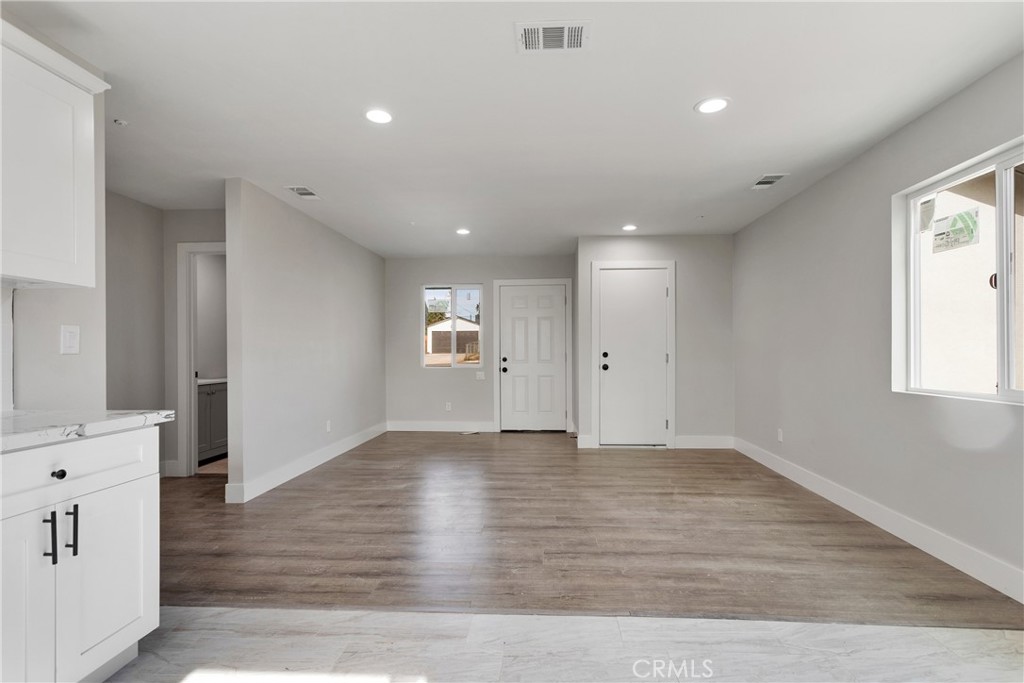 3308 Cannes Avenue Riverside, CA 92501 - Photo 11 of 38 an empty room with wooden floor and windows