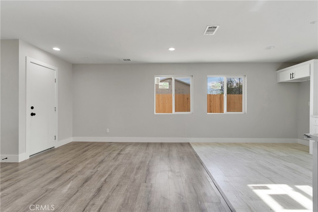 3308 Cannes Avenue Riverside, CA 92501 - Photo 13 of 38 a view of an empty room with wooden floor and a window