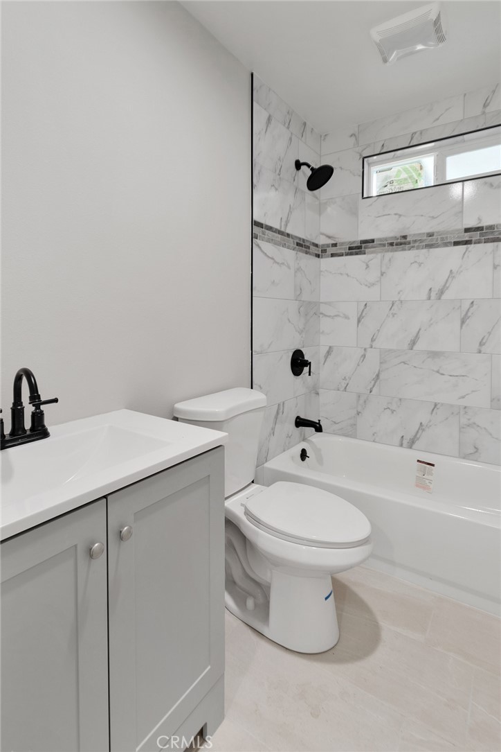 3308 Cannes Avenue Riverside, CA 92501 - Photo 15 of 38 a bathroom with a sink a toilet and shower