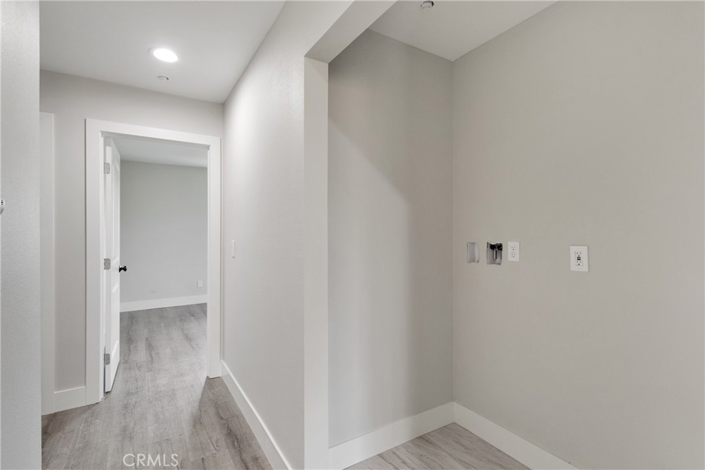 3308 Cannes Avenue Riverside, CA 92501 - Photo 16 of 38 a view of hallway with closet and wooden floor