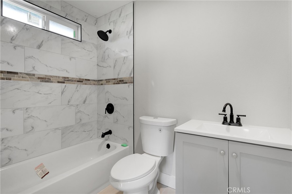 3308 Cannes Avenue Riverside, CA 92501 - Photo 20 of 38 a bathroom with a sink a toilet and a bathtub