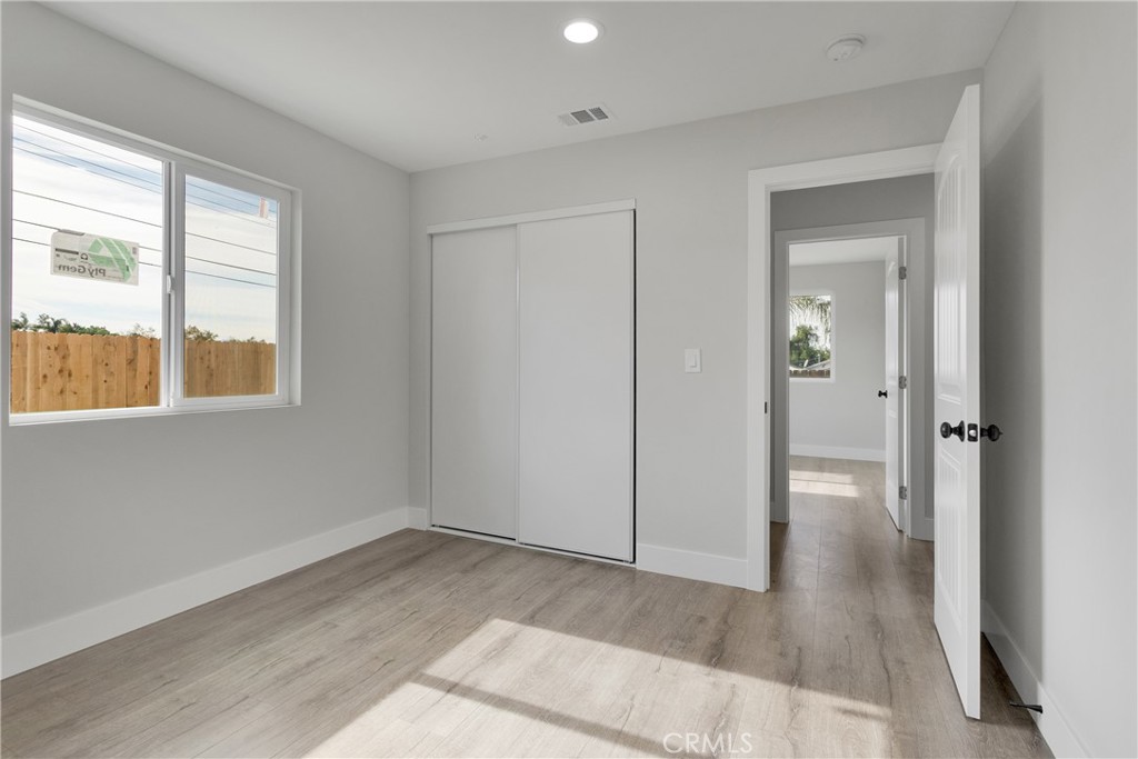3308 Cannes Avenue Riverside, CA 92501 - Photo 25 of 38 a view of an empty room with wooden floor and a window